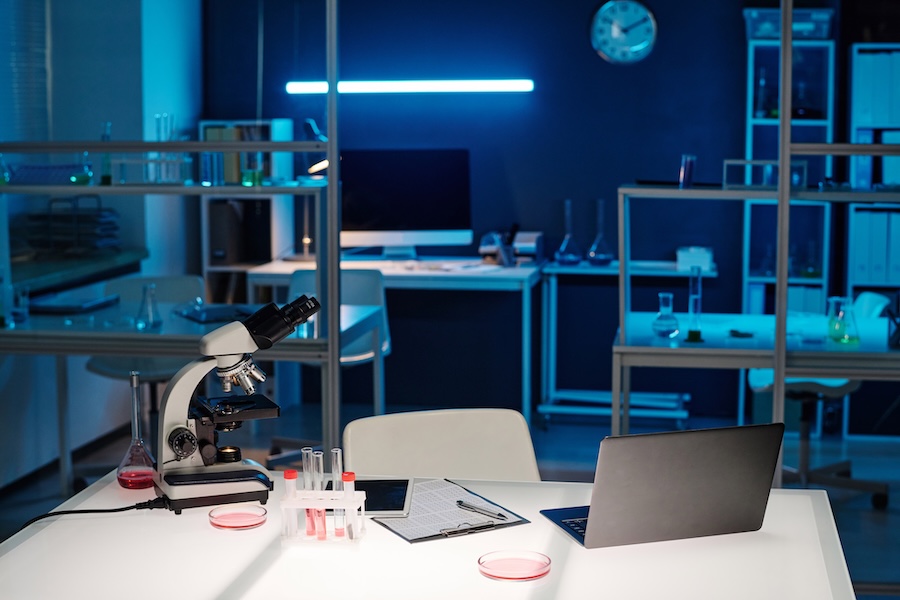 Workplace with glassware and professional technical equipment in scientific laboratory